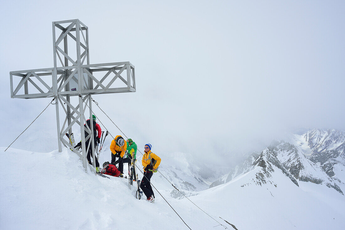 Group of back-country skiers at summit of Hoher Weisszint, Zillertal Alps, South Tyrol, Italy