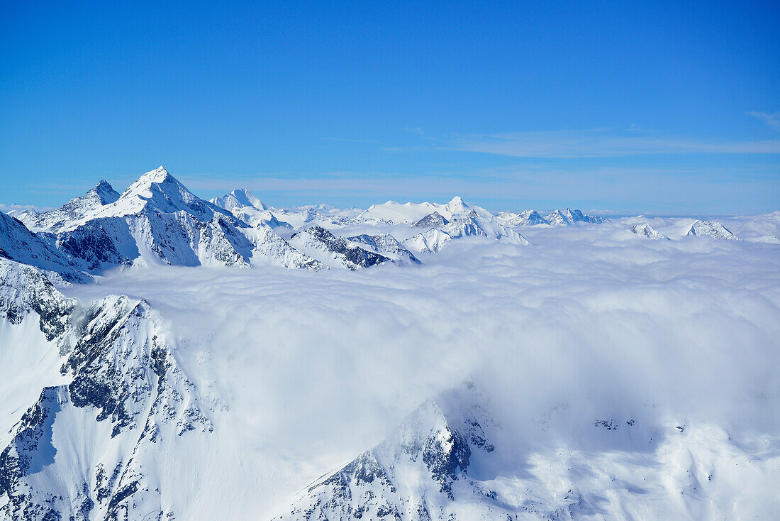 Snow-covered mountain scenery above sea of fog, Schlieferspitze, Venediger Group, Hohe Tauern National Park, Salzburg, Austria