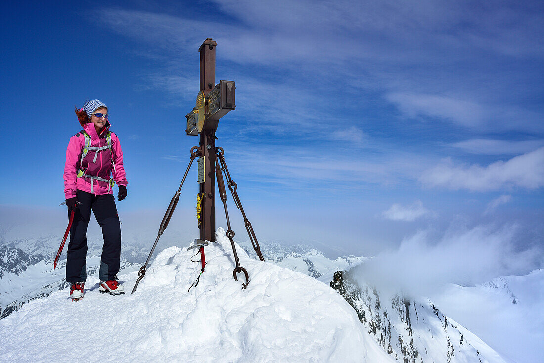 Woman beside summit cross of Grossglockner, Glockner Range, Hohe Tauern National Park, East Tyrol, Tyrol, Austria