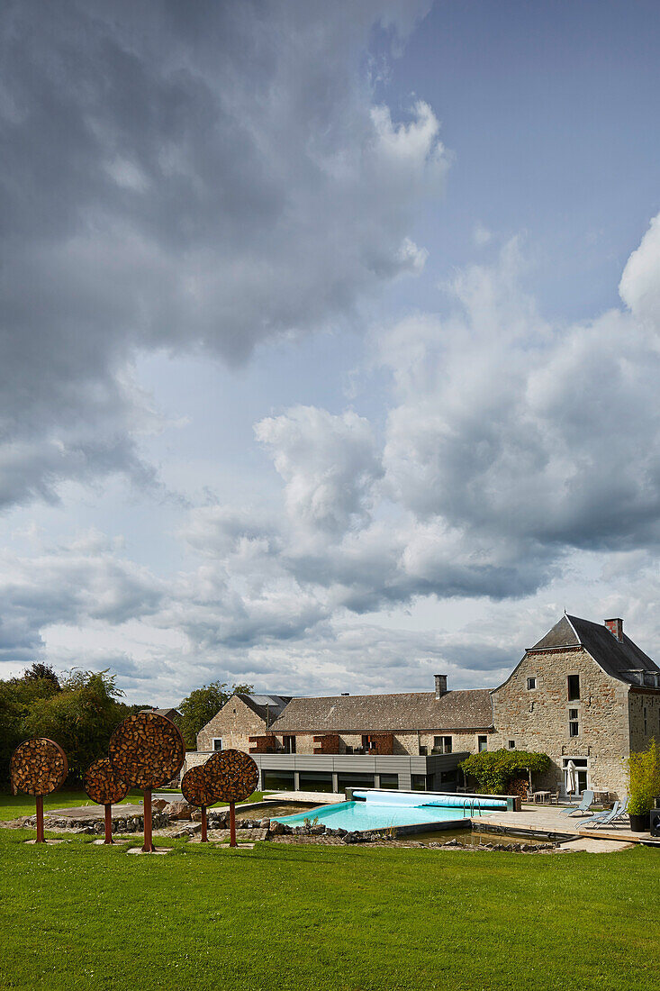 Outdoor area with pool of the Le Cor de Chasse, food hotel by Michelin starred gourmet chef Mario Elias, manor house built in 1681 in Durbuy, Rue des Combattants 16, Weris, Wallonia, Belgium
