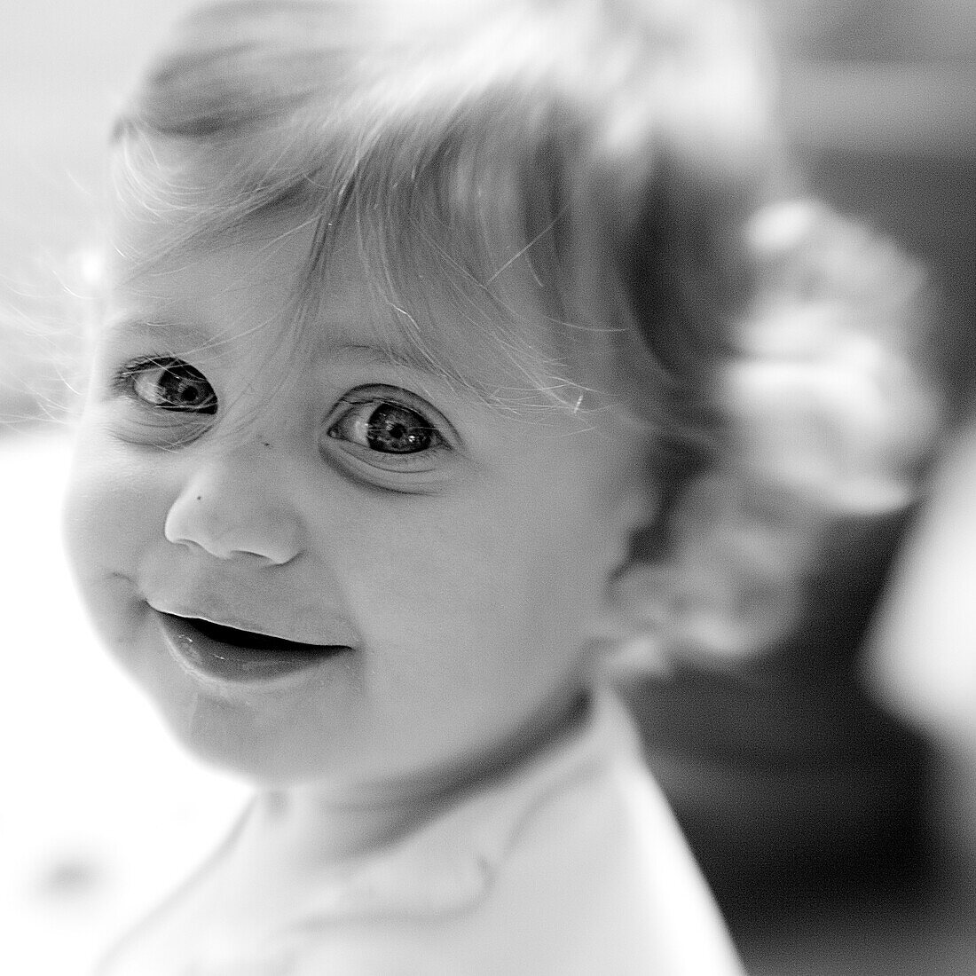 Smiling baby girl with big eyes (black and white photo using Lensbaby technique), Borden, Western Australia, Australia