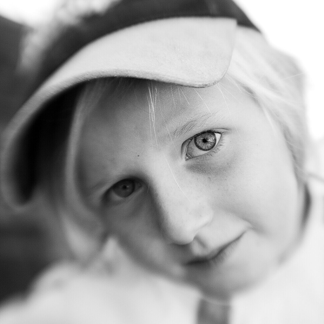 Blond boy with a cap looking into camera (black and white photo using Lensbaby technique), Borden, Western Australia, Australia