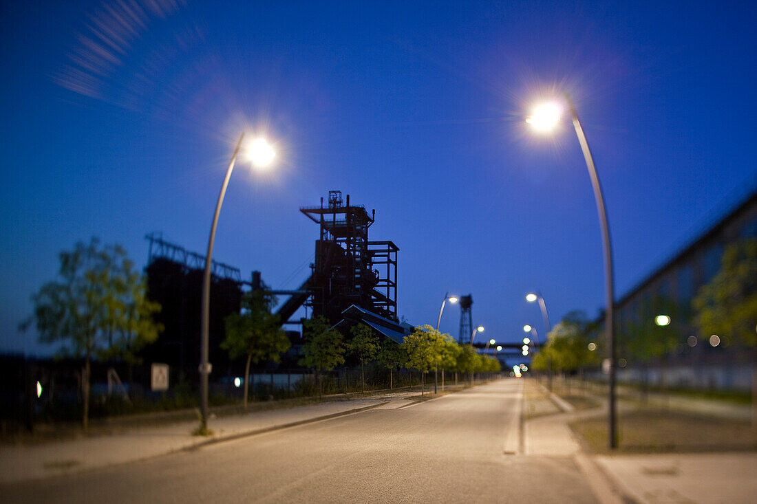 Old industrial buildings of the Hoerder Bergwerks- und Huetten Verein at dusk with street lamps (image using tilt-shift soft focus technique), Hoerde, near Dortmund, North Rhine-Westphalia, Germany, Europe