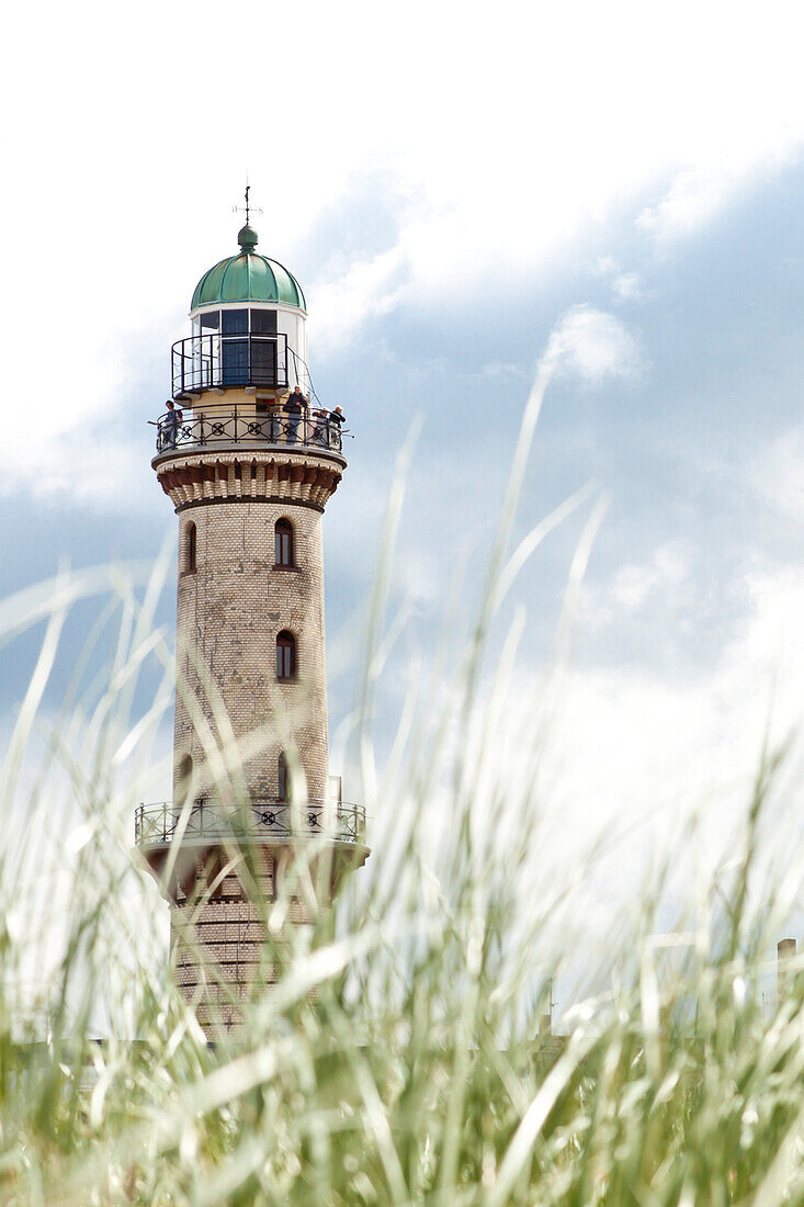 Warnemuende lighthouse seen through grasses, Warnemuende, Rostock, Mecklenburg-Pomerania, Germany, Europe