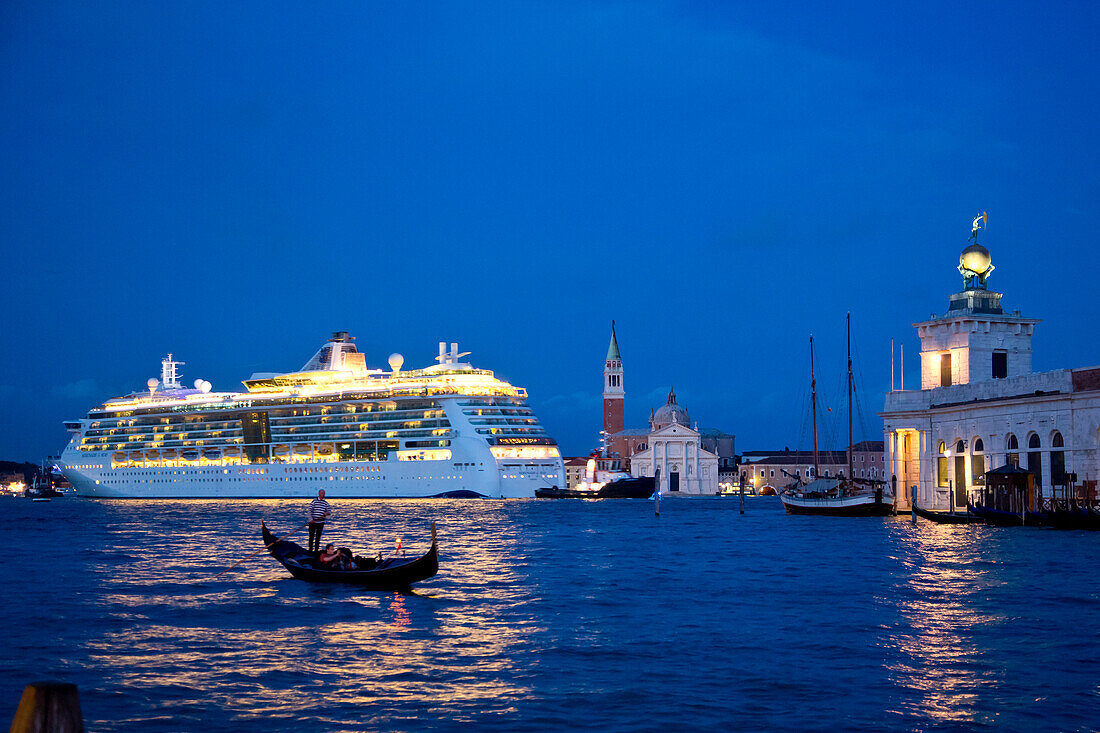 Silhouette of a gondola in front of cruise ship Serenade of the Seas (Royal Caribbean International) passing Isola di San Giorgo Maggiore island at dusk, Venice, Veneto, Italy, Europe