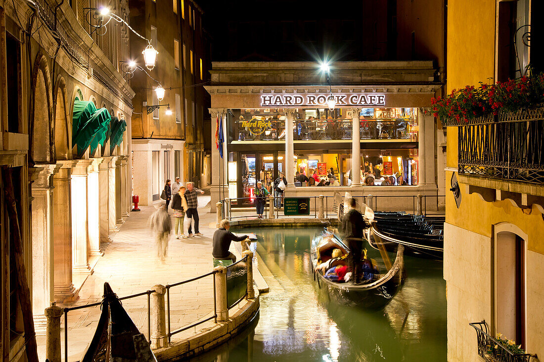 Exterior of Venice Hard Rock Cafe with approaching gondola at night, Venice, Veneto, Italy, Europe