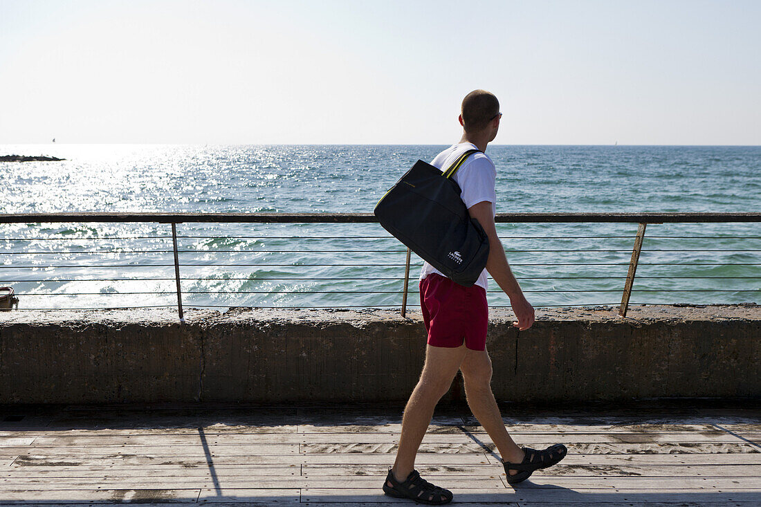Man walking along the port looking out to the Mediterranean Sea, Tel-Aviv, Israel, Asia