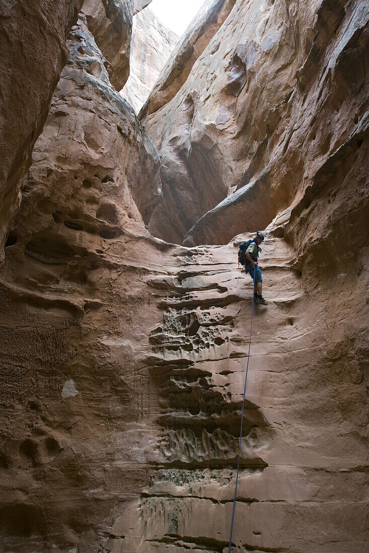 Josh Williams rappelling down the North Fork of Robbers Roost Canyon, Robbers Roost Country, Utah.  Whit Richardson / Aurora Photos 