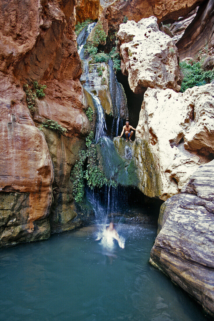 Dave and Angelina jumping in, Wolf in Elves Chasm which is a tributary canyon area to the Colorado river which rafters hike up during river trips, Grand Canyon, Arizona.  Whit Richardson / Aurora Photos 