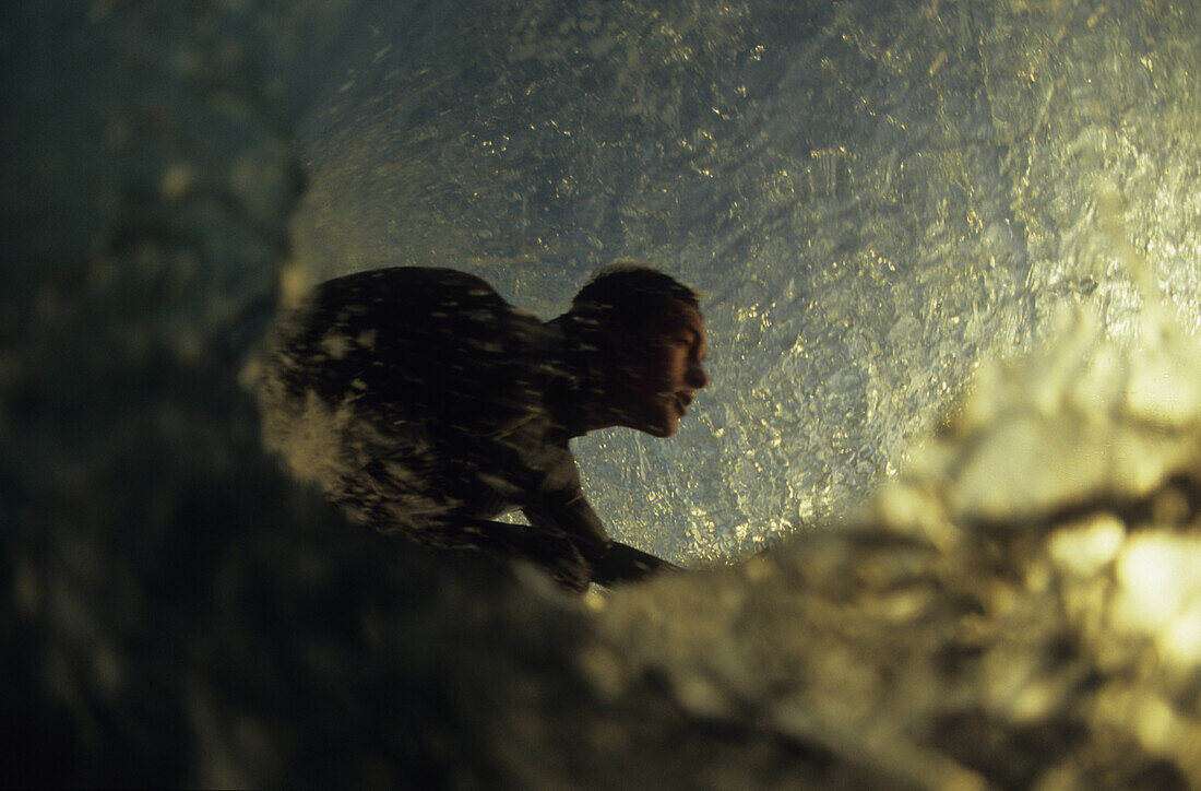 Iain Harris leanes forward in an early morning tube in San Diego, California.