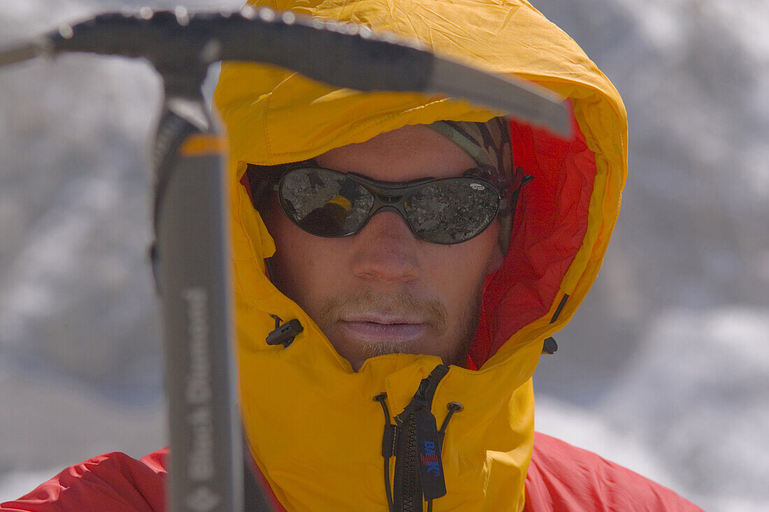 A mountaineer with his ice axe on Cho Oyu in Tibet, China.