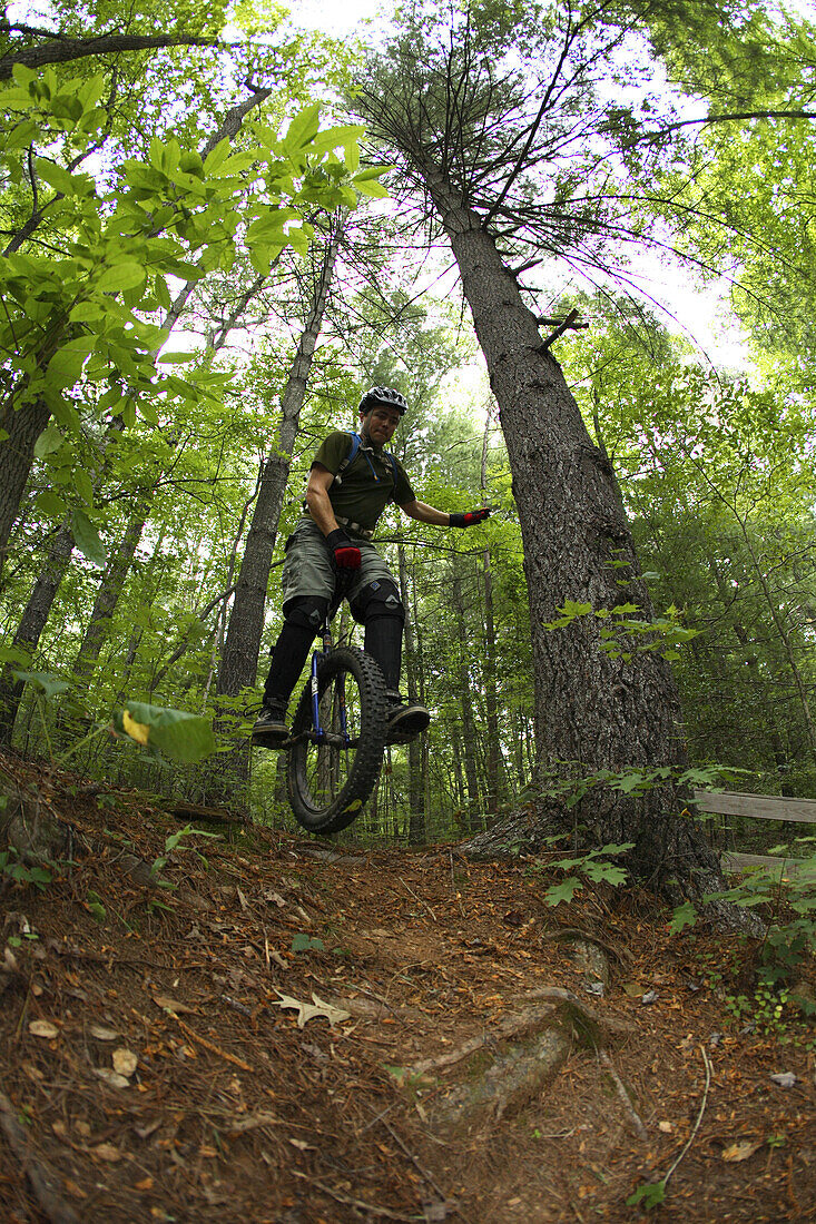 Adam Masters rides his mountain unicycle around Lake Powhatan in the Bent Creek Experimental Forest near Asheville, NC.