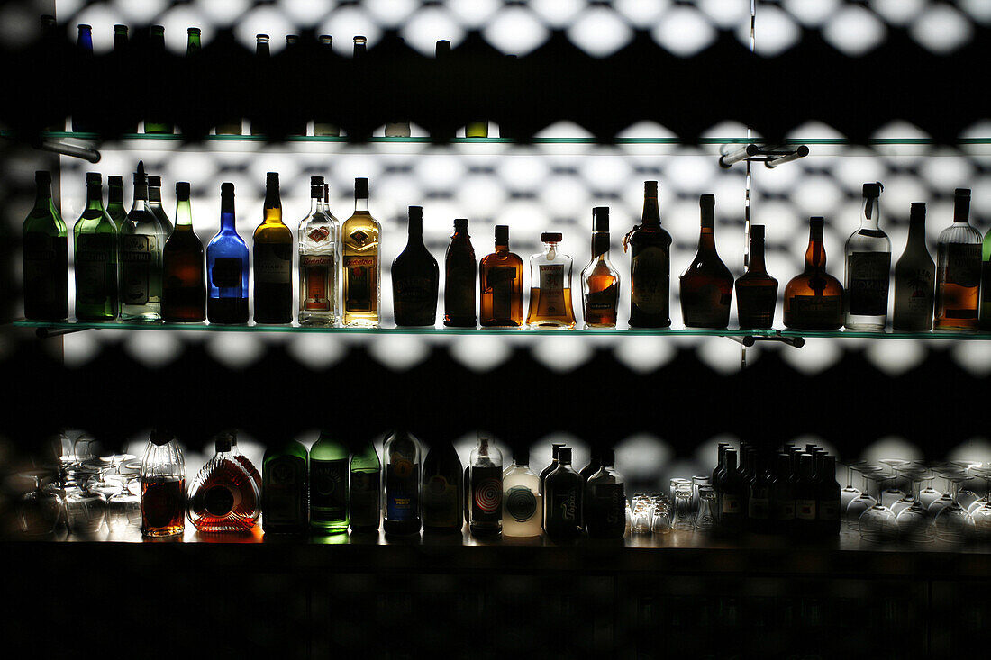 Drinks and bottles at a bar illuminated at a bar in Rekiavik, Iceland.
