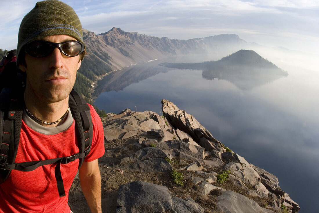 Young man hiking at Crater Lake National Park, Oregon.  releasecode: 050.jpg