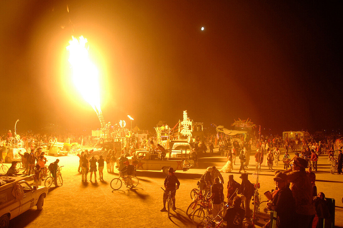 'Artists display their work which include extensive pyrotechnics, and revelers enjoy music and dance on the ''Playa'', the central couryard area at the Burning Man festival. The event attracted 35,000 visitors in 2006 and the modo boasts ''no visitors, on