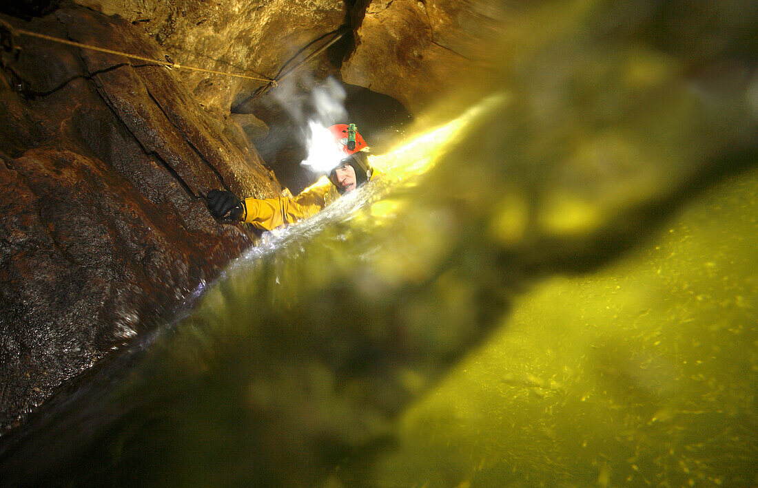 Rob Eavis deep fast flowing streamway in Speedwell Cavern, England