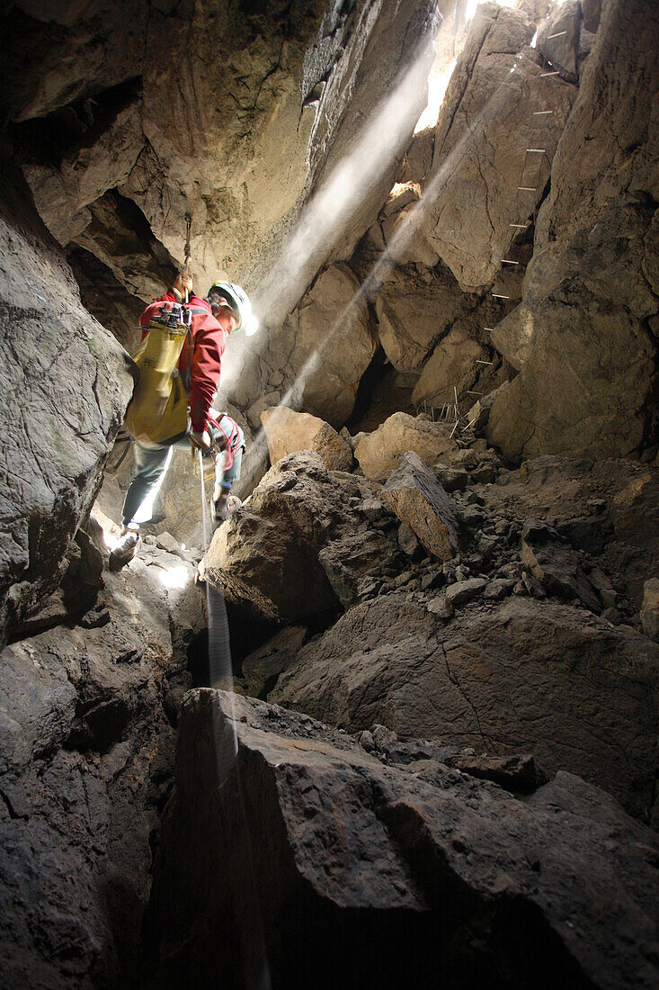 Rob Eavis descends into a daylight lit underground chamber in the White Mountains on the island of Crete.