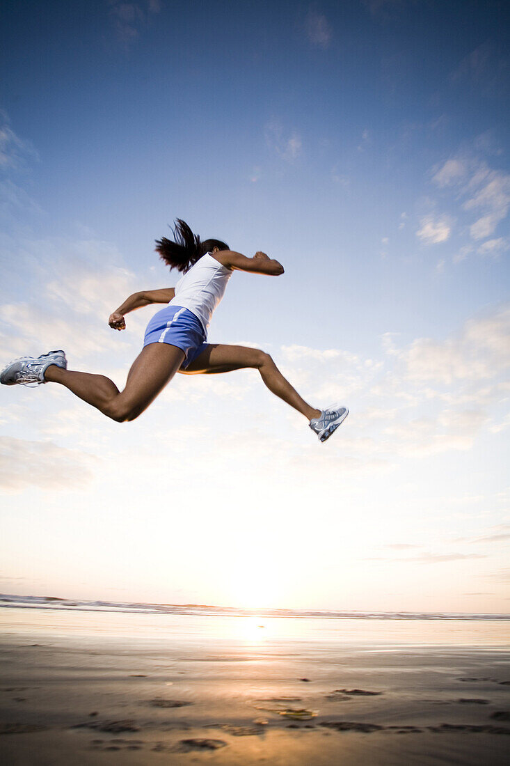 A woman runs in athletic gear in Oceanside, California.