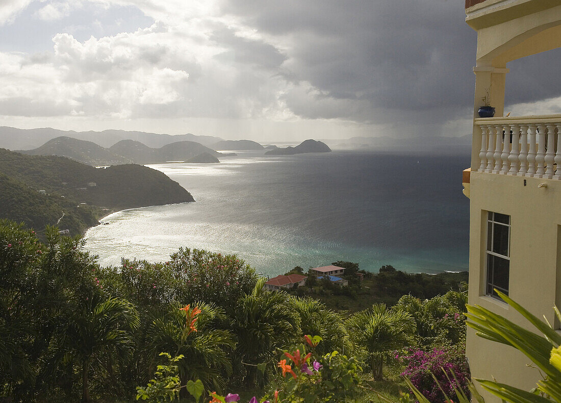 High atop one of Tortola's many hills, a house commands a dramatic view of Brewers Bay, looking west across Tortola toward St John in the British Virgin Islands