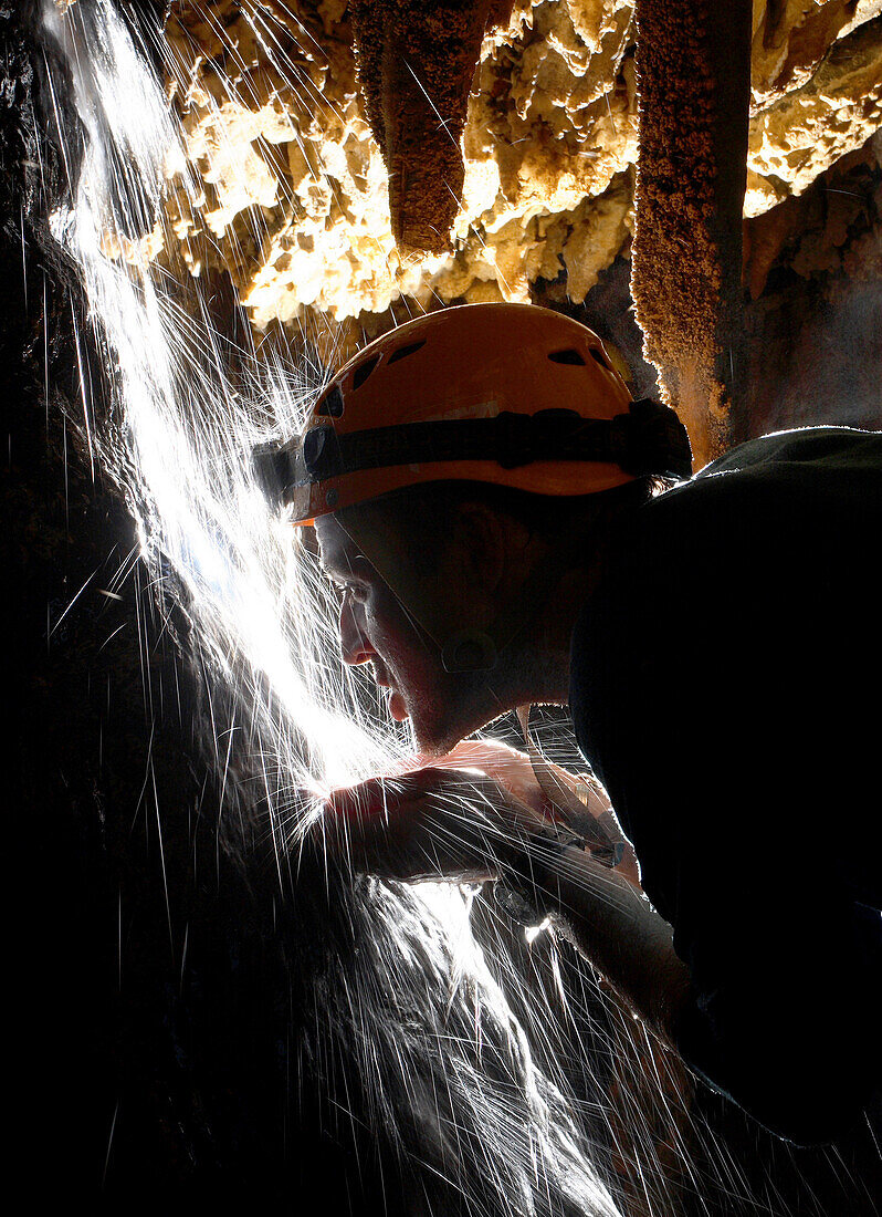 Cave explorer Mark Wright leans into an underground stream of water to quench his thirst in Moon Cave in Mulu National Park in Sarawak Borneo, February 2, 2007. Mark Wright was part of a group of British explorers that mapped an additional 26 kilometers o