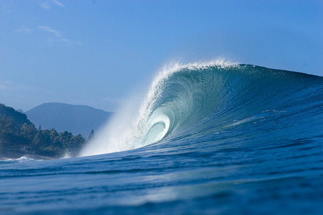 tubing wave at Gas Chambers, on the north shore of Oahu, Hawaii