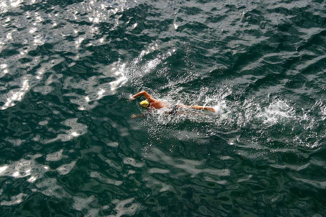 A swimmer does few laps for training before the start of the Sydney Harbour Swim Classic.