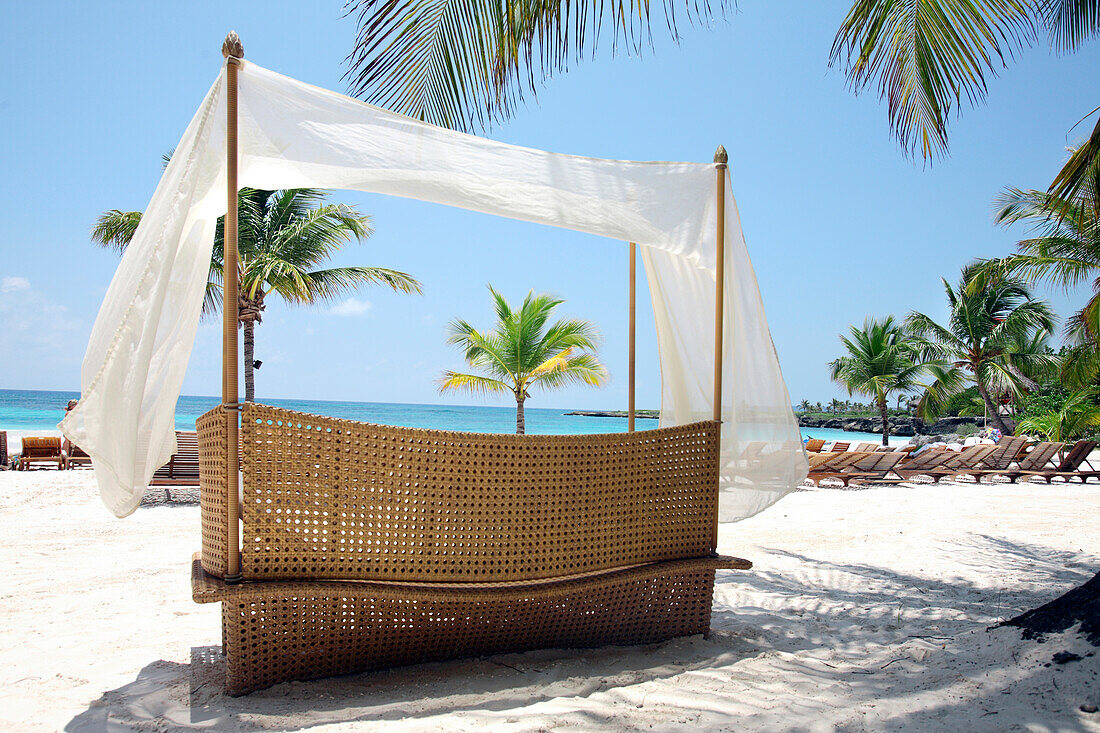 Cap Cana, Dominican Republic - April 12: A canopied bench sits nexton the beach at the Caleton Beach Club in Cap Cana, Dominican Republic, April 12, 2007.