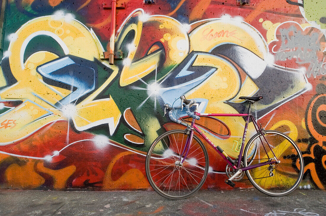 A Basso bicycle leans against a graffiti covered wall near Portland, Maine's water treatment plant along a bike path that wraps around Portland's Eastern Promenade, around the back bay, and into the old port.