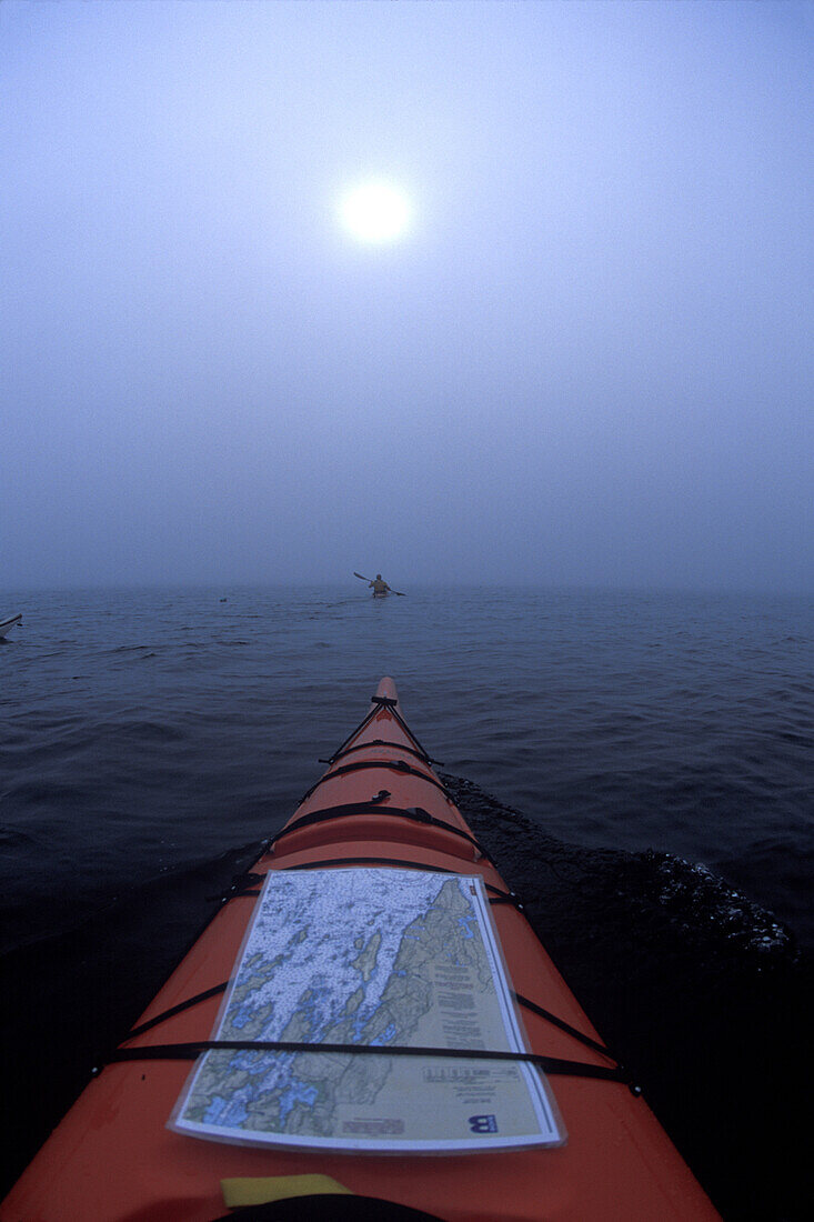 View from the bow of a sea kayak near Thief Island on Muscungus Bay, Maine.