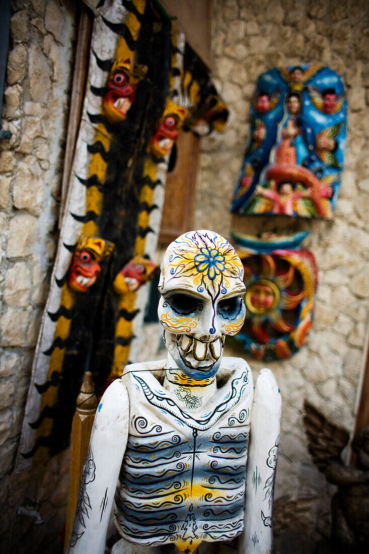 A painted carved  skeleton is on display in Playa del Carmen, Mexico.