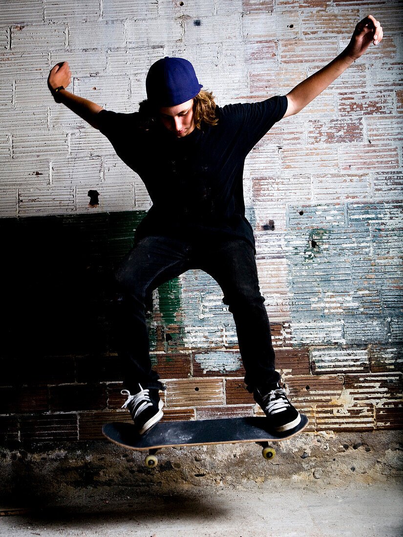 High school aged skateboarder doing an ollie, Oceanside, California.