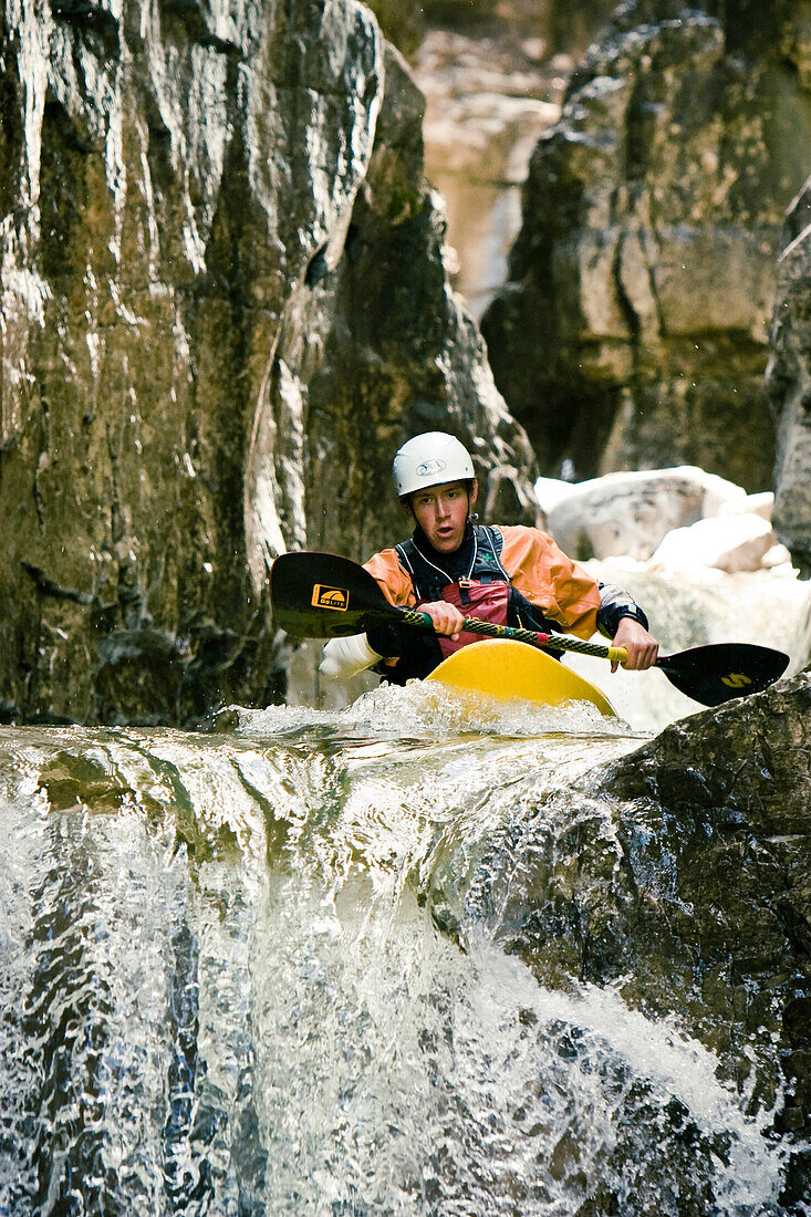 Scott Japhet kayaking the tight slot canyon of Cascade Falls near Durango Colorado, prepares for a waterfall with a 15 foot drop.