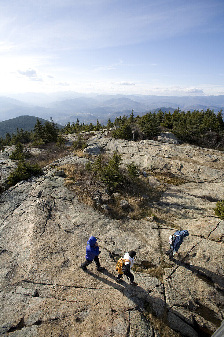 Anna Romer and Jose Azel hike with their daughter Sasha Azel to reach the peak of Mount Kearsarge, on the eastern fringe of the White Mountains of New Hampshire, on a sunny fall day.