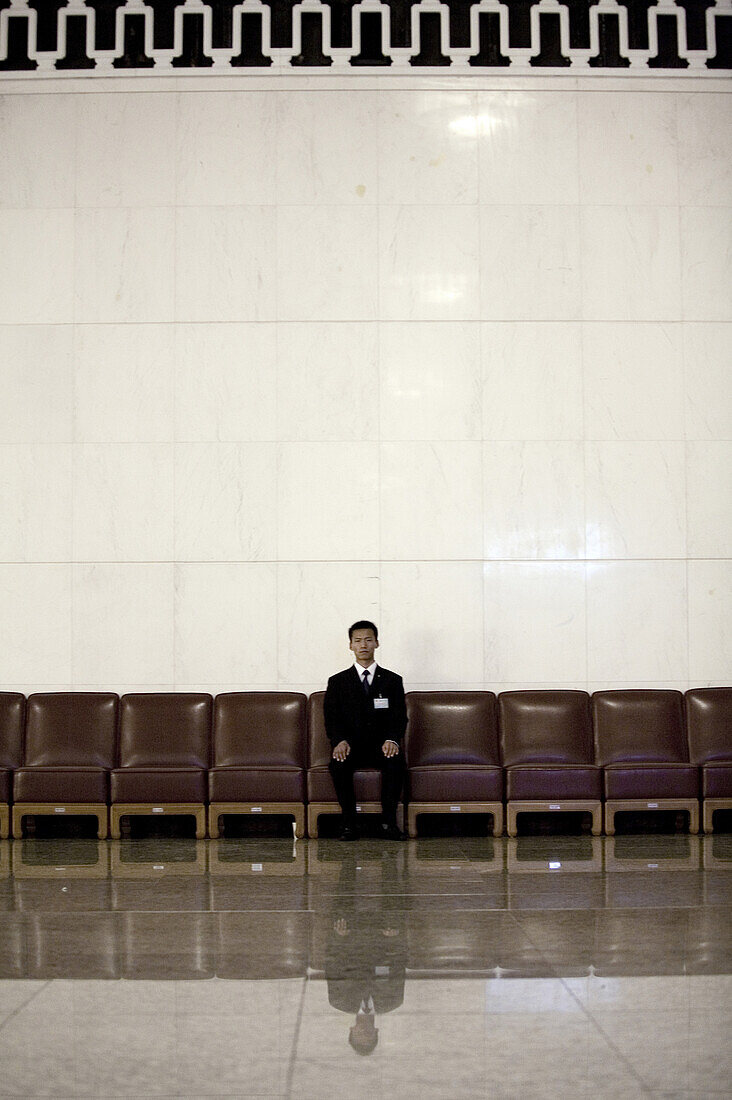 A Chinese attendant in the Great Hall of the People during a session of the National People's Congress, China's Parliament.