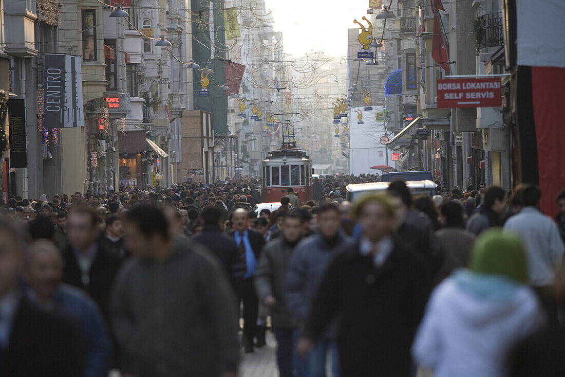 Istanbul, Turkey - January, 2008: The busy pedestrian street called Istiklal which leads up to Taksim square in Istanbul, Turkey is home to many of the cities most popular shops, bars and cafes and has an old fashioned tram running its length .