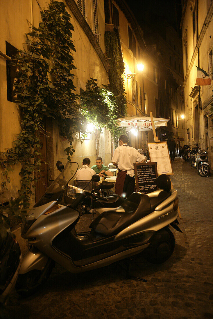 Eating out at night at an outdoor cafe in Rome, Italy.