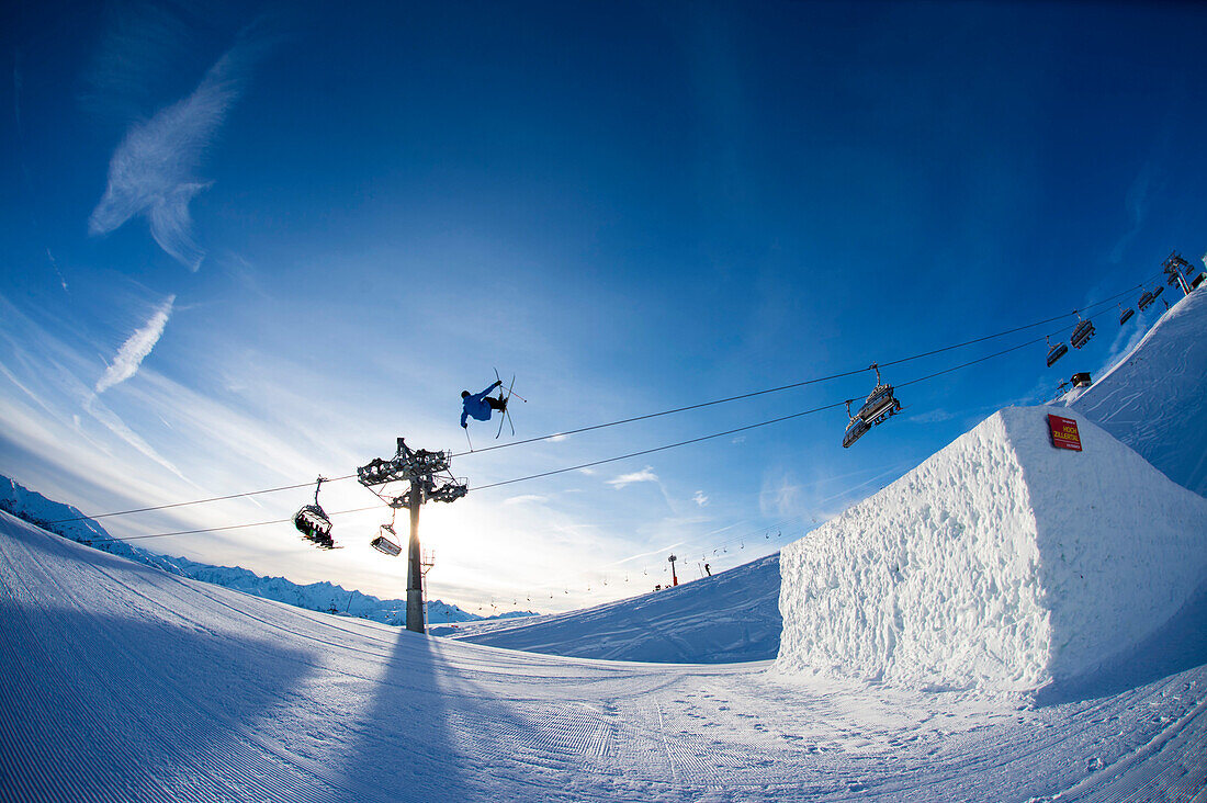 Skier jumping over big kicker in fun park, Betterpark, Kaltenbach, Zillertal, Austria