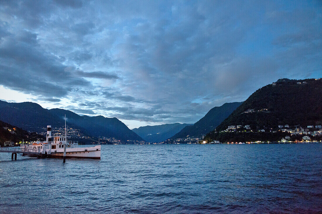 View from the lake promenade in Como over Lake Como at dusk, Lombardy, Italy, Europe