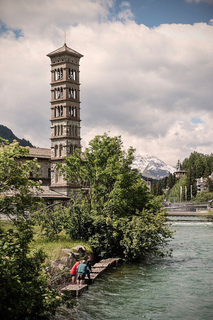 Church tower and tributarystream to lake St. Moritz, Engadin, Grisons, Switzerland