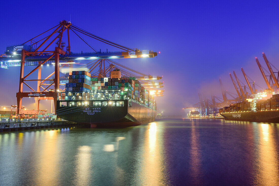 Container ships at illuminated container terminal Burchardkai at night, Waltershof, Hamburg, Germany