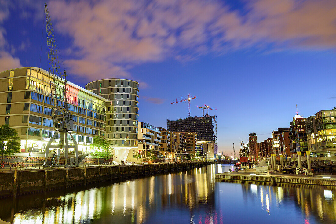 Illuminated port Sandtorhafen with Elbphilharmonie in background, Hafencity, Hamburg, Germany