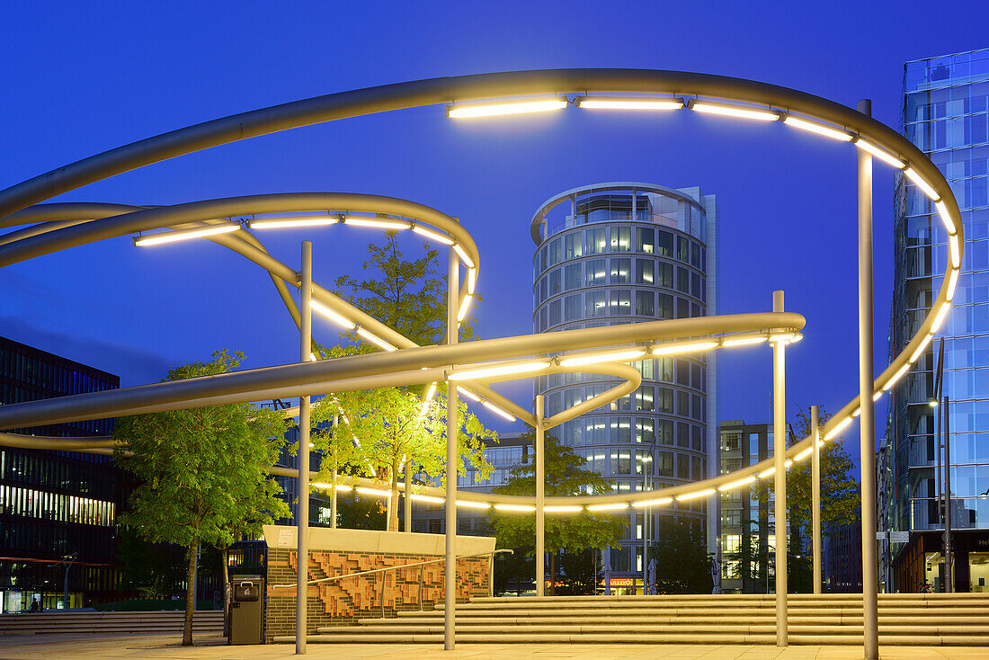 Illuminated Magellan Terrassen with Coffee Plaza building in the background, Sandtorhafen, Hafencity, Hamburg, Germany