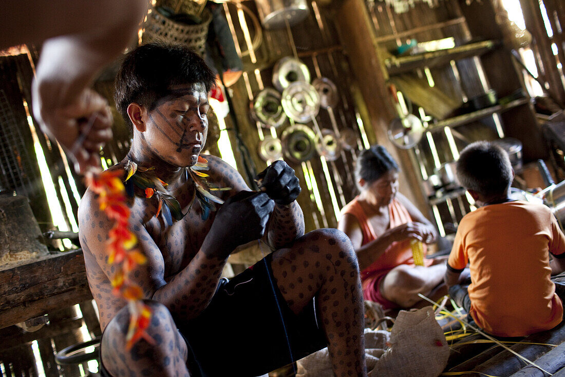 'Nham pa, in foreground, and Maria make preparations for a traditional ''festa'', Sao Luis Indian Post, Brazil.'