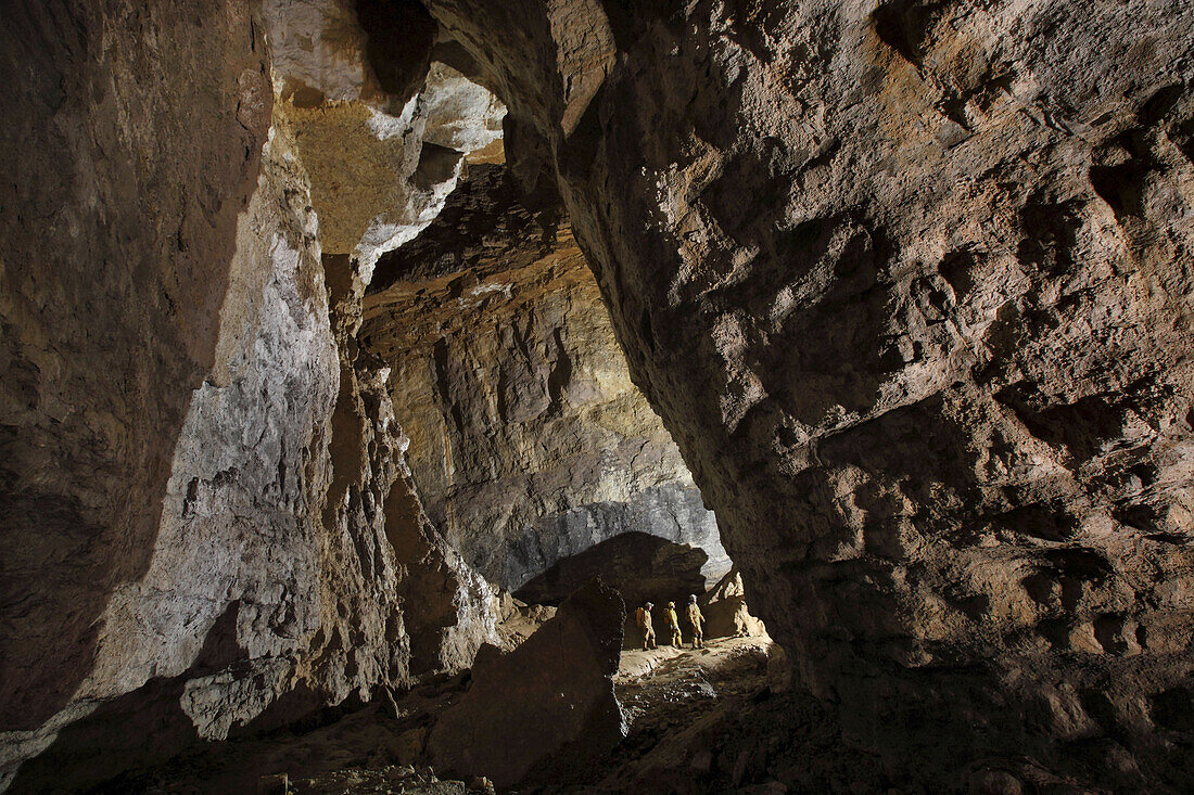 Three British cave explorers make their way down the main gallery, part of the classic famous cave in France called The Gouffre Berger high in the Vercors region.