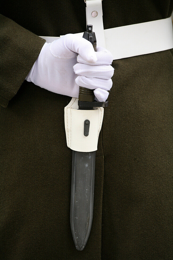 Dolmache Palace- Guard with white glove holds a knife
