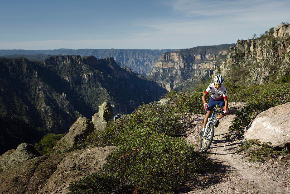 'A young mountain biker riding on a trail called ''Ruta del Toro'' in guachochi,  Chihuahua,  Mexico.'