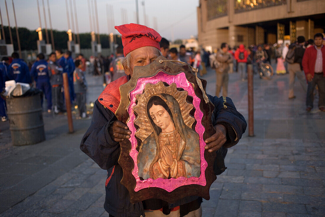 A pilgrim carries an image of the Our Lady of Guadalupe outside of the Our Lady of Guadalupe Basilica in Mexico City,  December 10,  2011. Hundreds of thousands of Mexican pilgrims converged on the Basilica,  bringing images to be blessed,  as processions