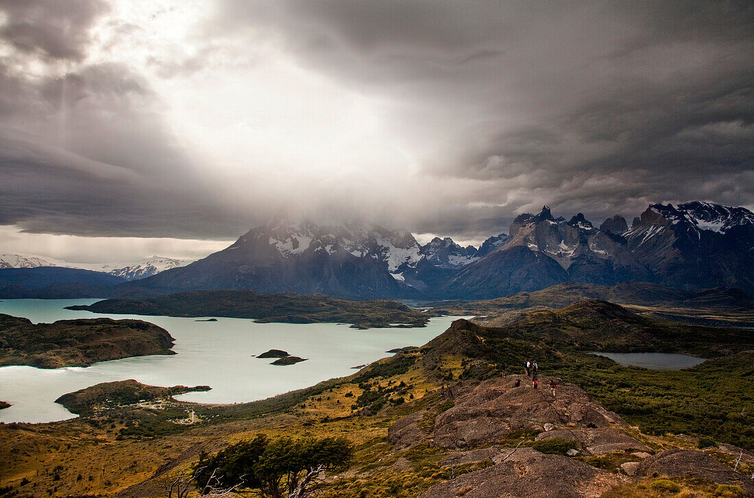 TORRES DEL PAINE NATIONAL PARK, PATAGONIA, CHILE. Hikers enjoy one of the best national parks in South America on a sunny day. With steep peaks full of hanging glaciers and glacial silt-filled lakes, Torres del Paine is one of the greatest attractions on 