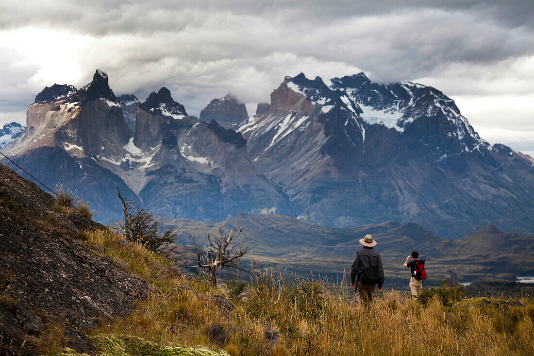 TORRES DEL PAINE NATIONAL PARK, PATAGONIA, CHILE. Hikers enjoy one of the best national parks in South America on a sunny day. With steep peaks full of hanging glaciers and glacial silt-filled lakes, Torres del Paine is one of the greatest attractions on 