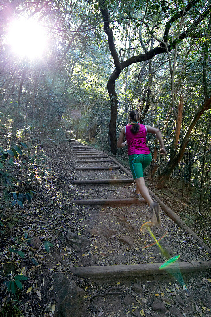 Susann Scheller running on one of the many trails of Cape Town Botanical Gardens.  Table Mountain, Cape Town, South Africa.